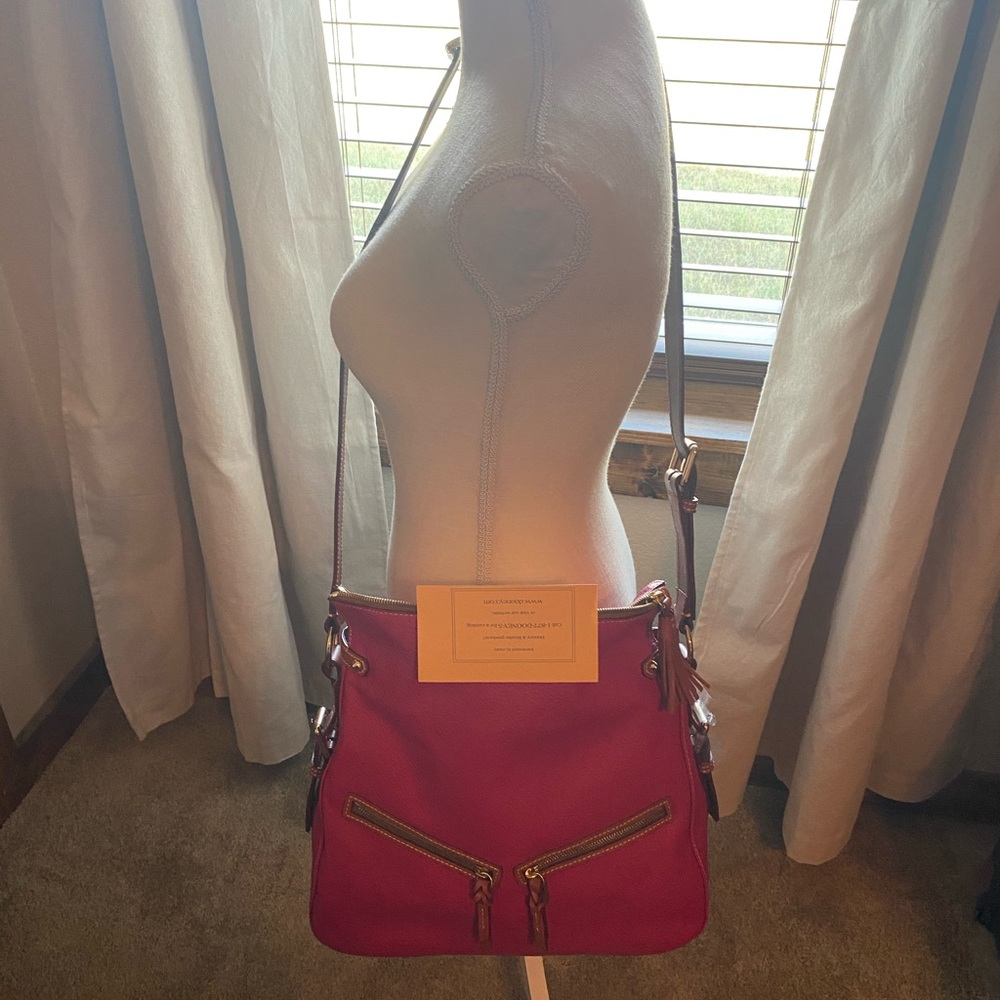 Dooney & Bourke new leather pink raspberry colored bag with registration card.